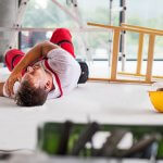 Man laying on the floor injured, after an accident on a building site