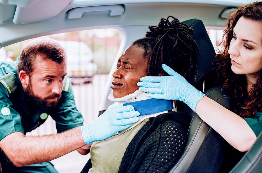 Woman being treated for whiplash following a car accident