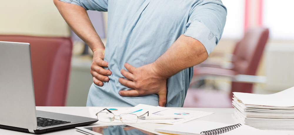 Claim Compensation for a Back Injury at Work Man suffering back pain at work