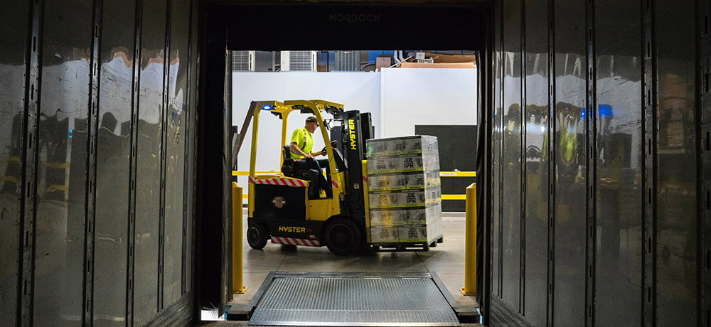 A forklift unloading a truck