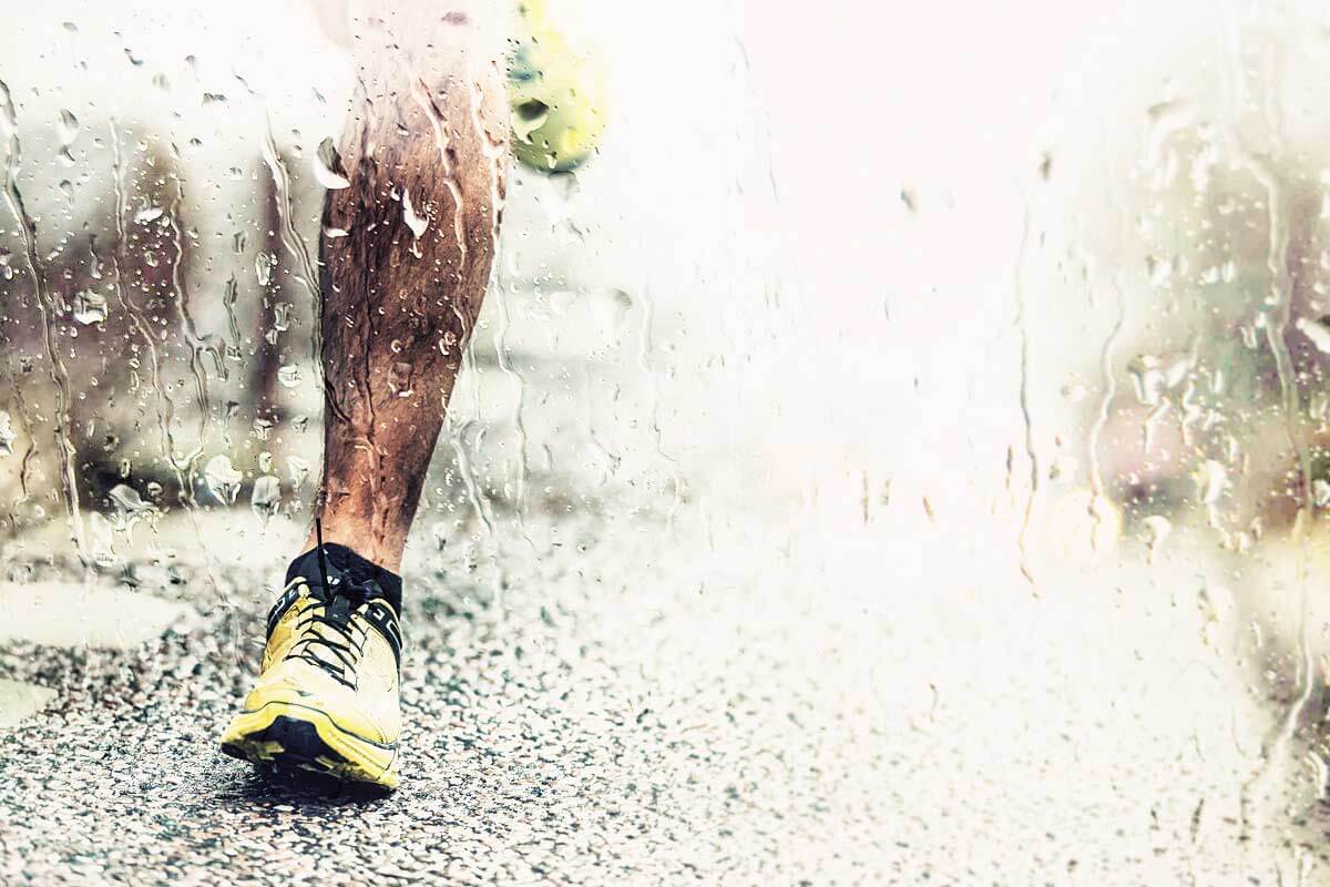 A runner on the road in the rain