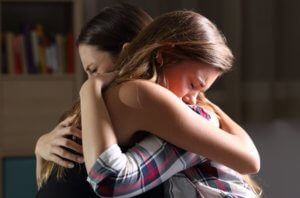 mother and daughter comforting each other after accident