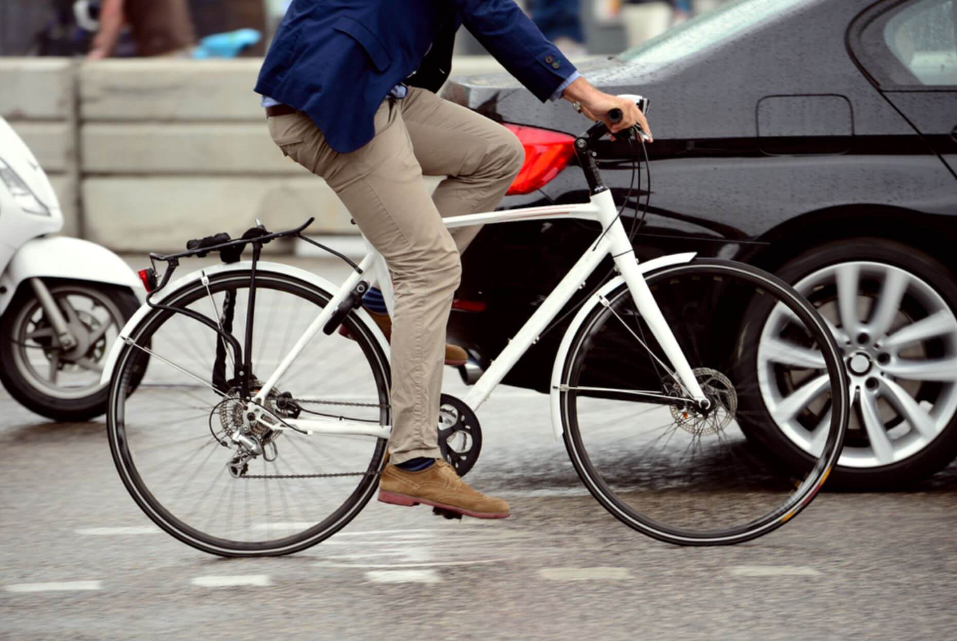 cyclist next to car on road