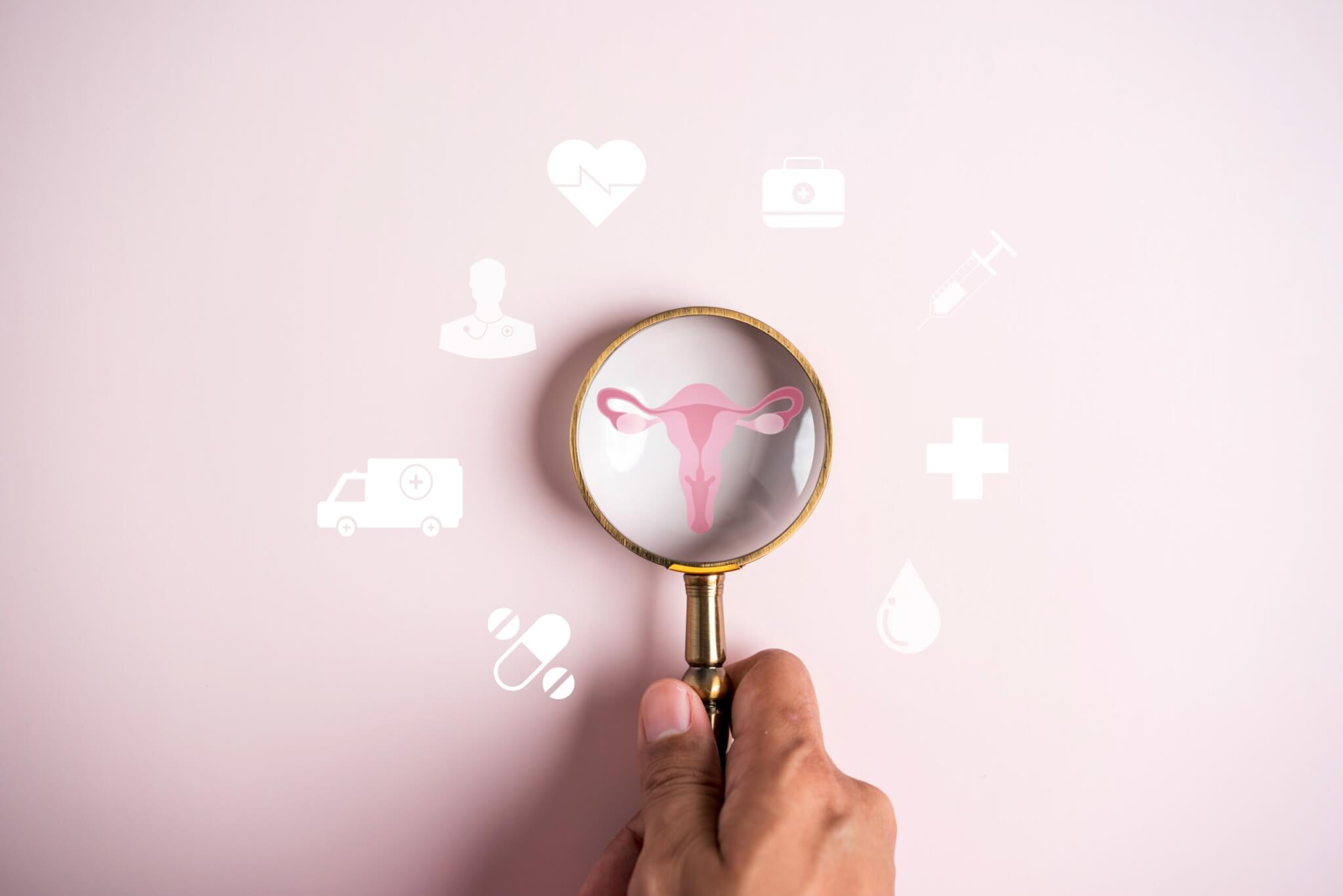 Medical icons with magnifying glass over an image of the uterus