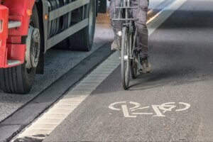 Cyclist being closely overtaken by a truck.