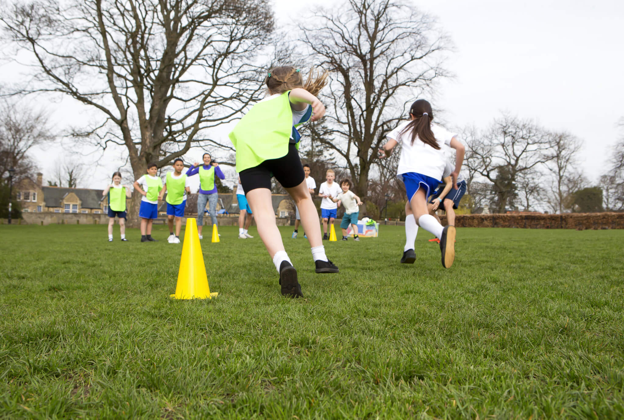 Children doing PE on a playing field