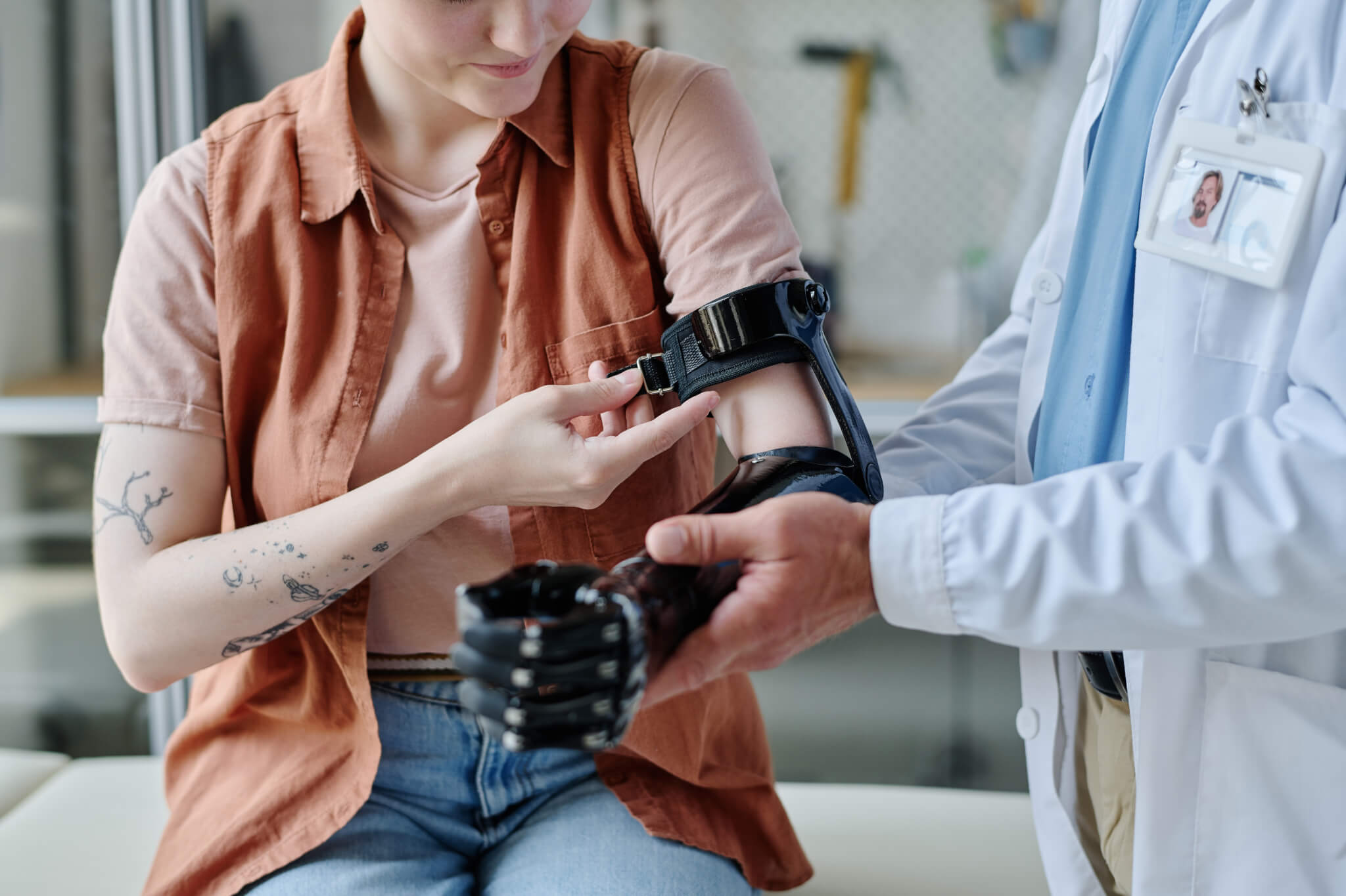 Close up of young woman having a prosthetic arm fitted.